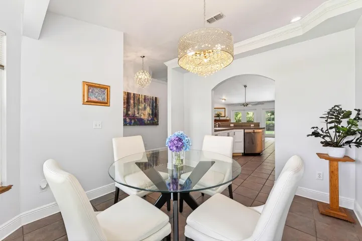 Beautiful ceramic tile flooring flows throughout the main living areas, while GRACEFUL ARCHITECTURAL DETAILS throughout the home add character and charm.