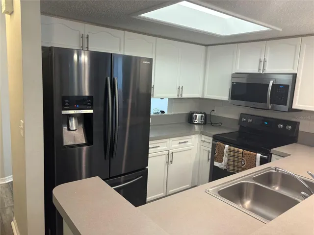 Kitchen with newer appliances.