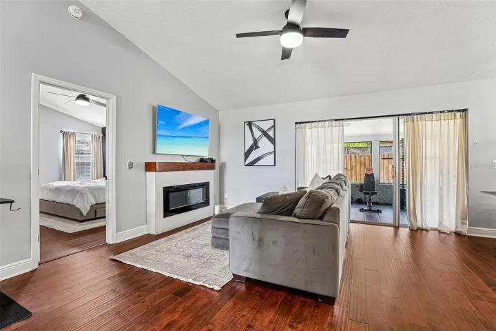 Living area has triple sliding glass doors that open to the screened lanai.