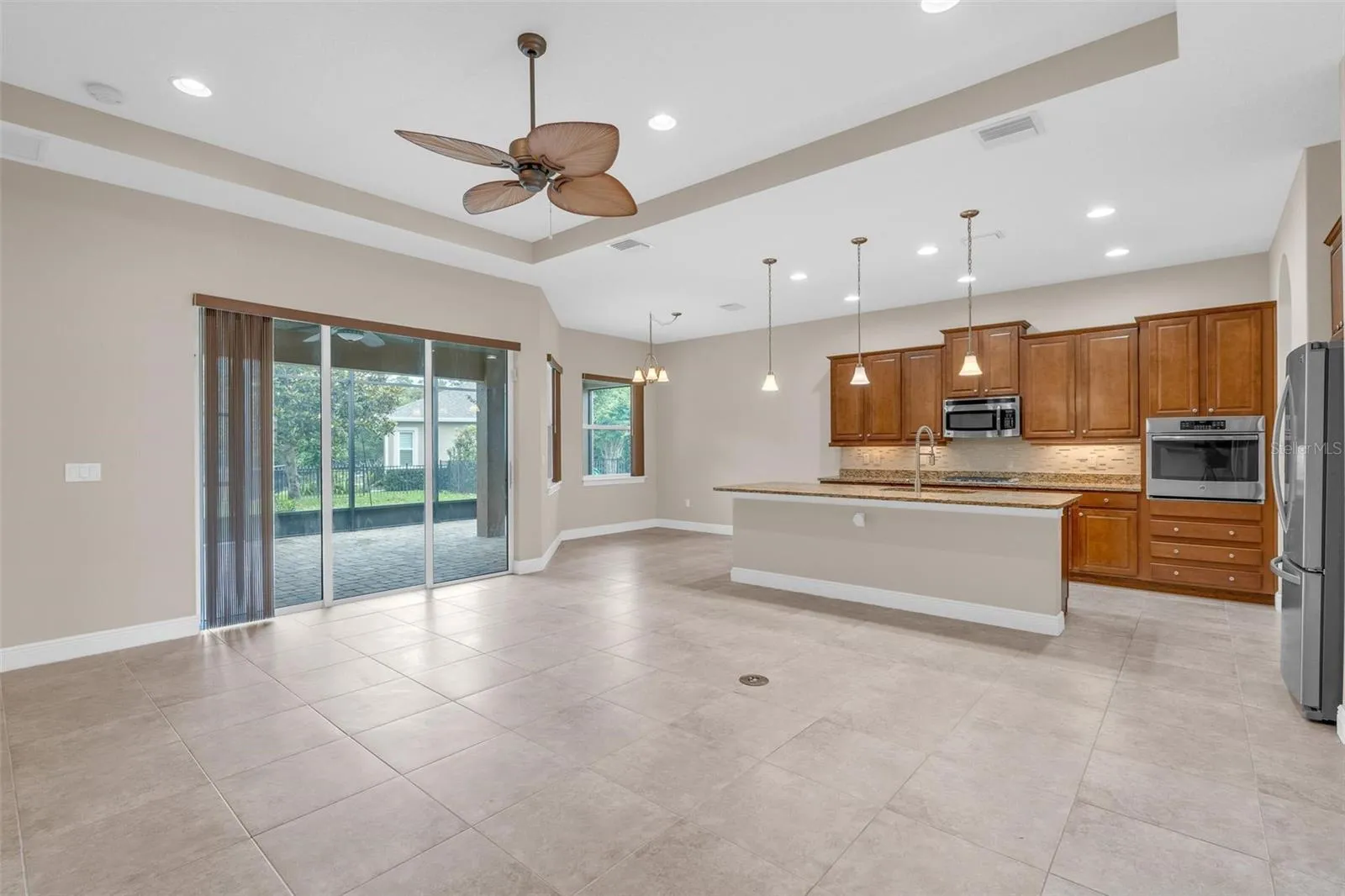 LIVING/DINING KITCHEN WITH SLIDERS TO SCREENED PATIO