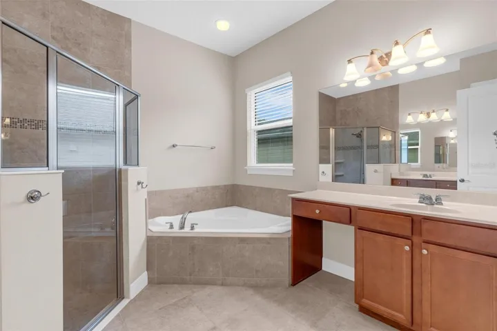 PRIMARY BATHROOM. DUAL SINKS, SOAKING TUB + WALK IN SHOWER