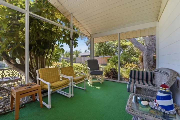 Screened lanai at side of home. Privacy and high ceiling