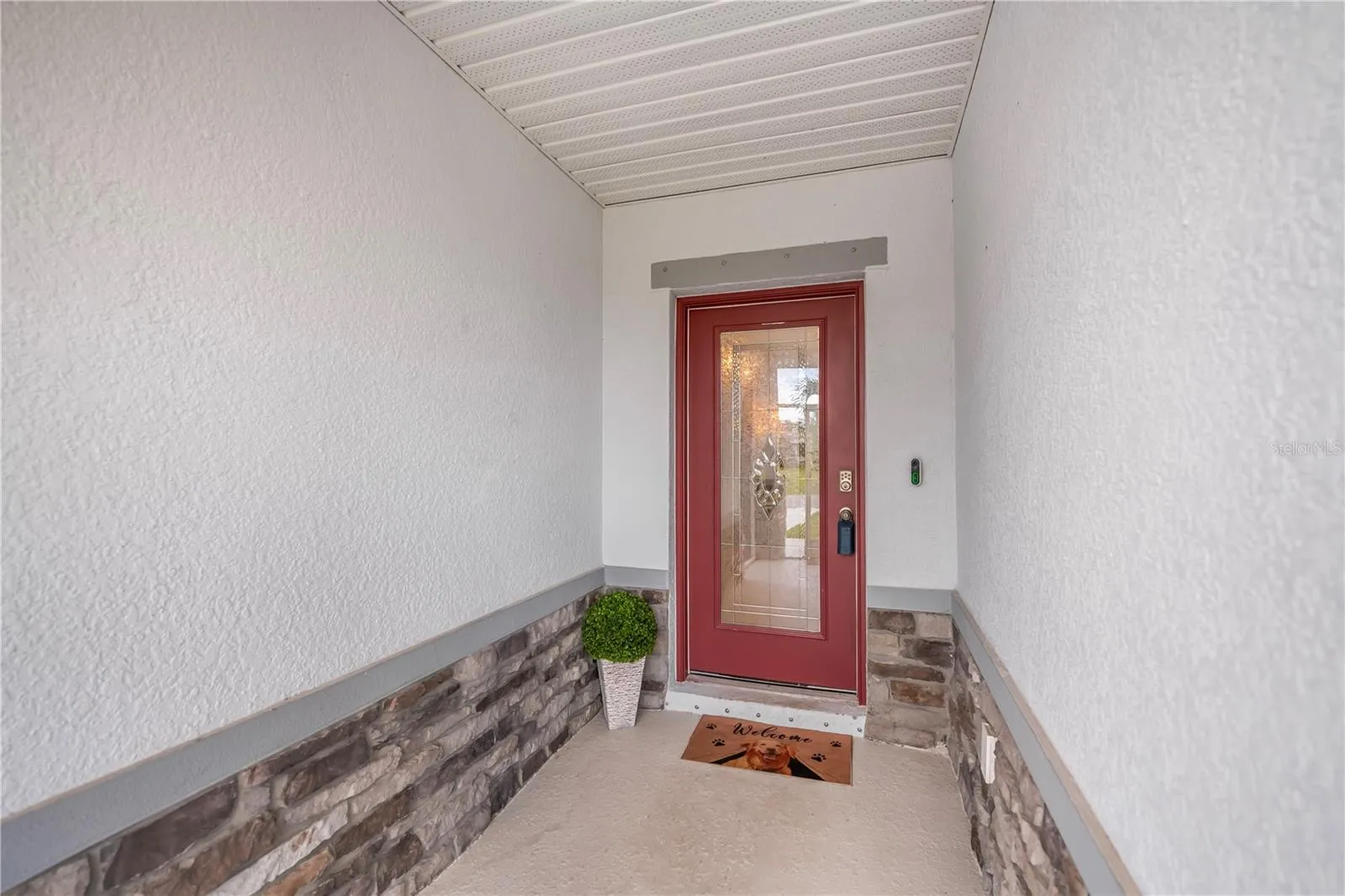 Elegant Leaded Glass Front Door with Decorative Stone Accents and Screen Entry.