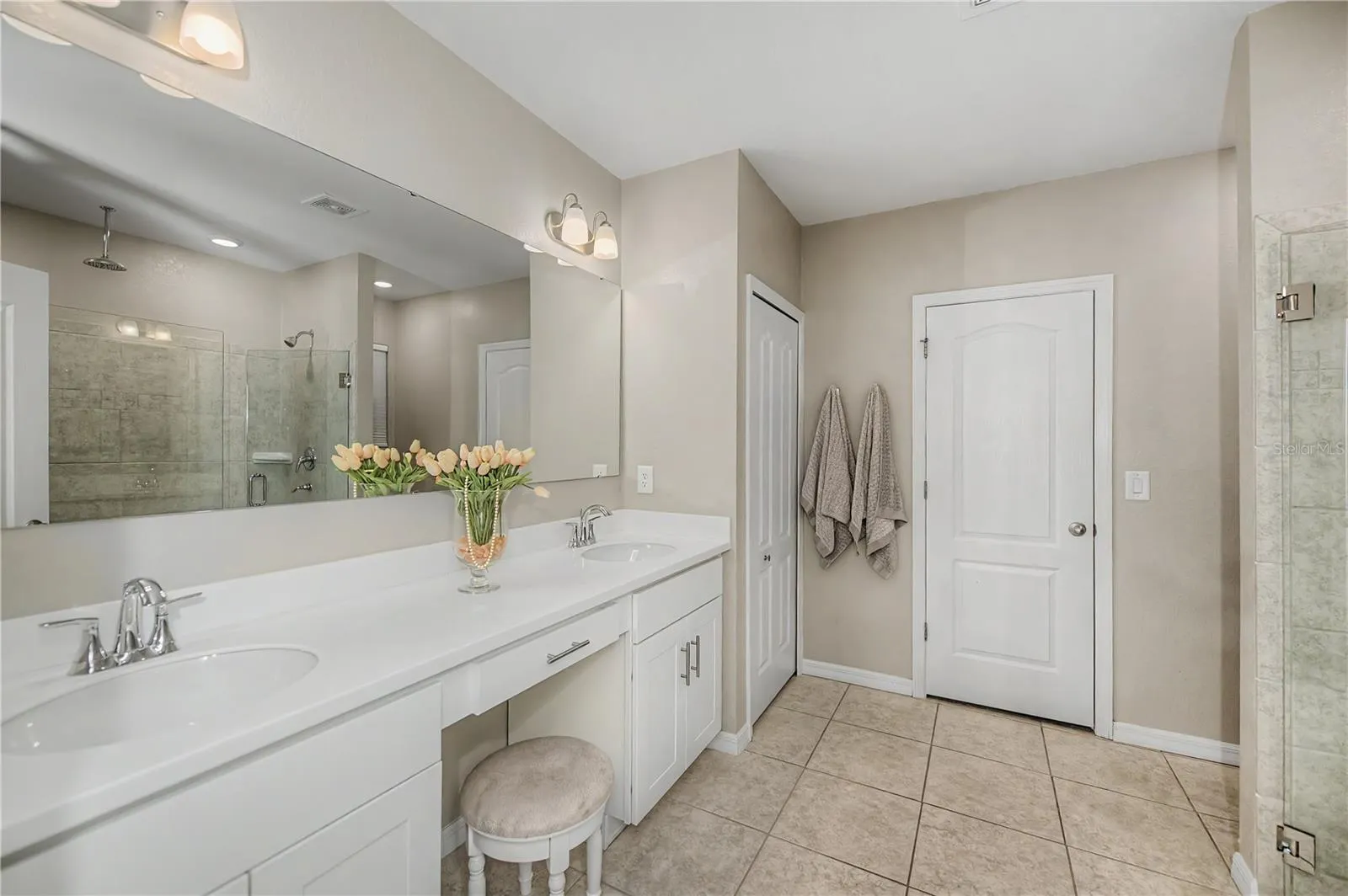 Spa Inspired Primary Bath with Dual Vanities and Makeup Area.