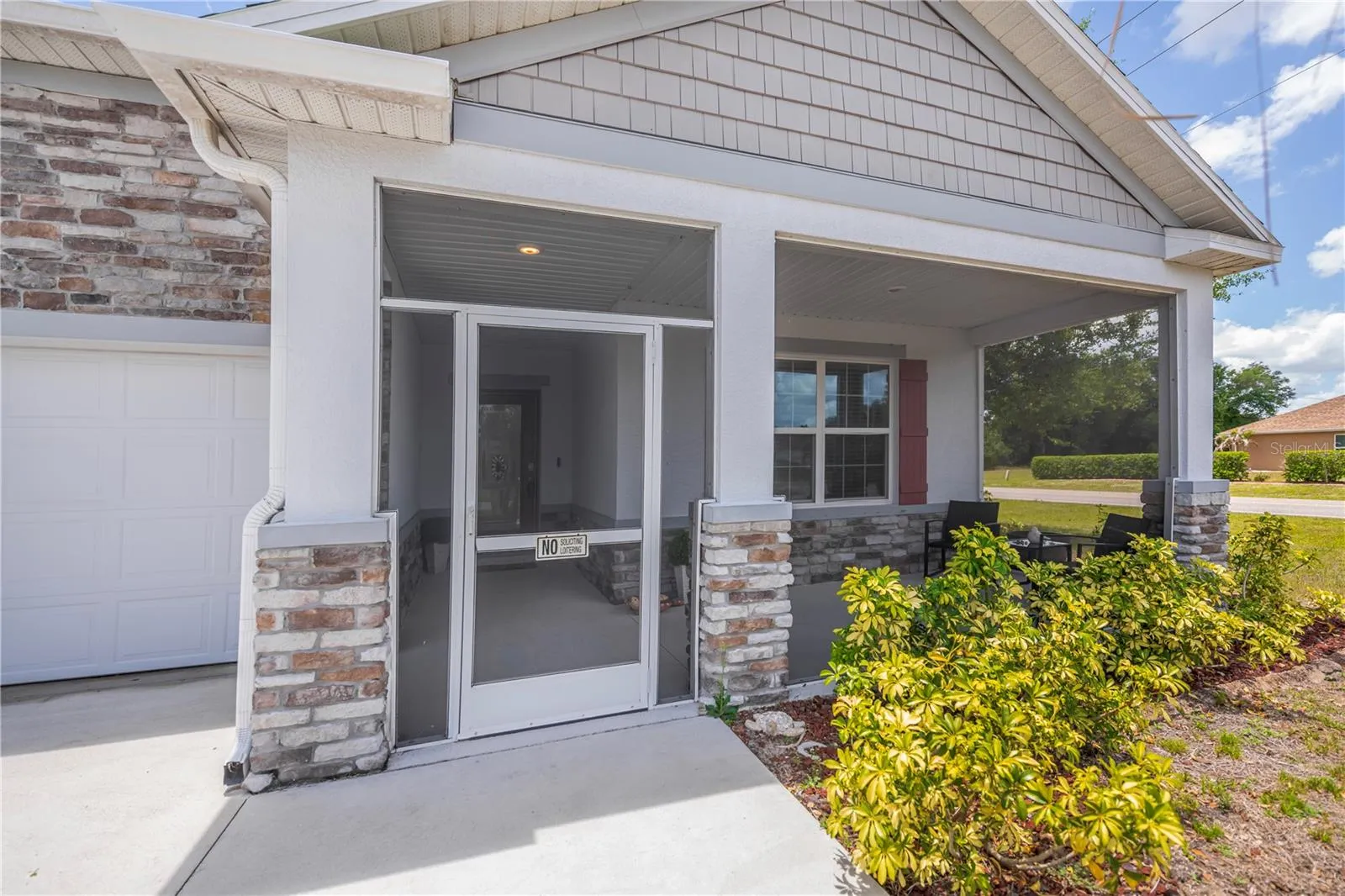 Screened Front Entry with Stone Accents.