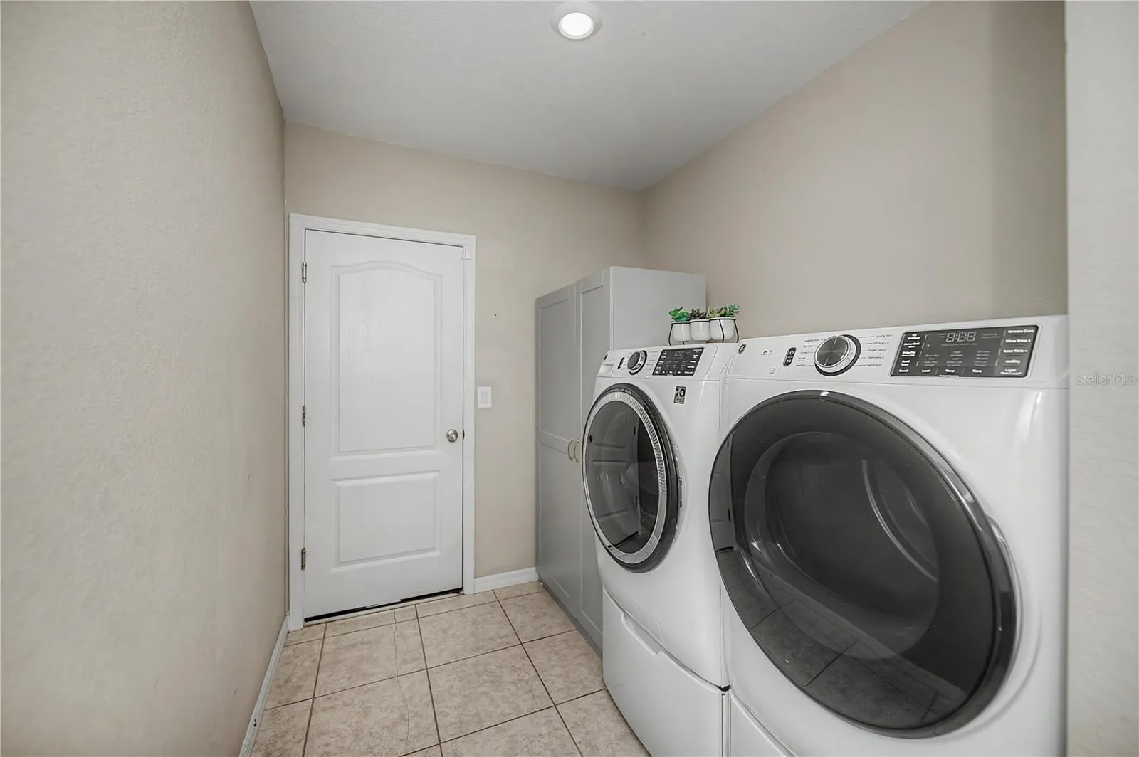 Spacious Interior Laundry Room with Additional Storage.