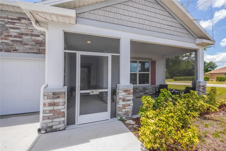 Screened Front Entry with Stone Accents.