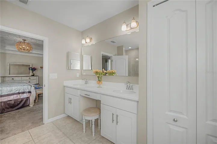 Spa Inspired Primary Bath with Dual Vanities and Makeup Area.