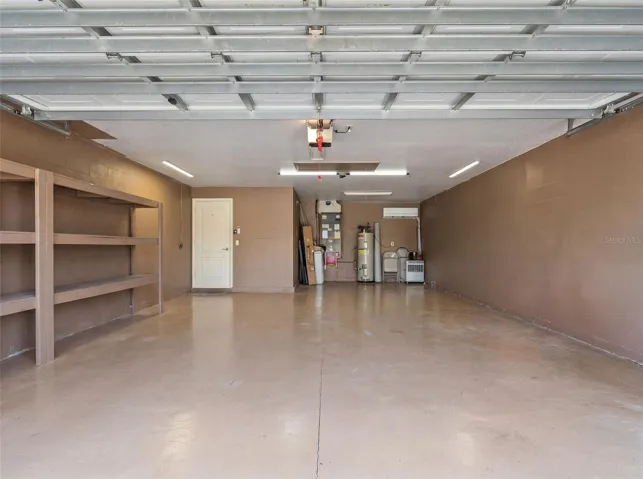 Garage with storage shelves, mini-split A/C unit and insulation in attic to keep garage cool