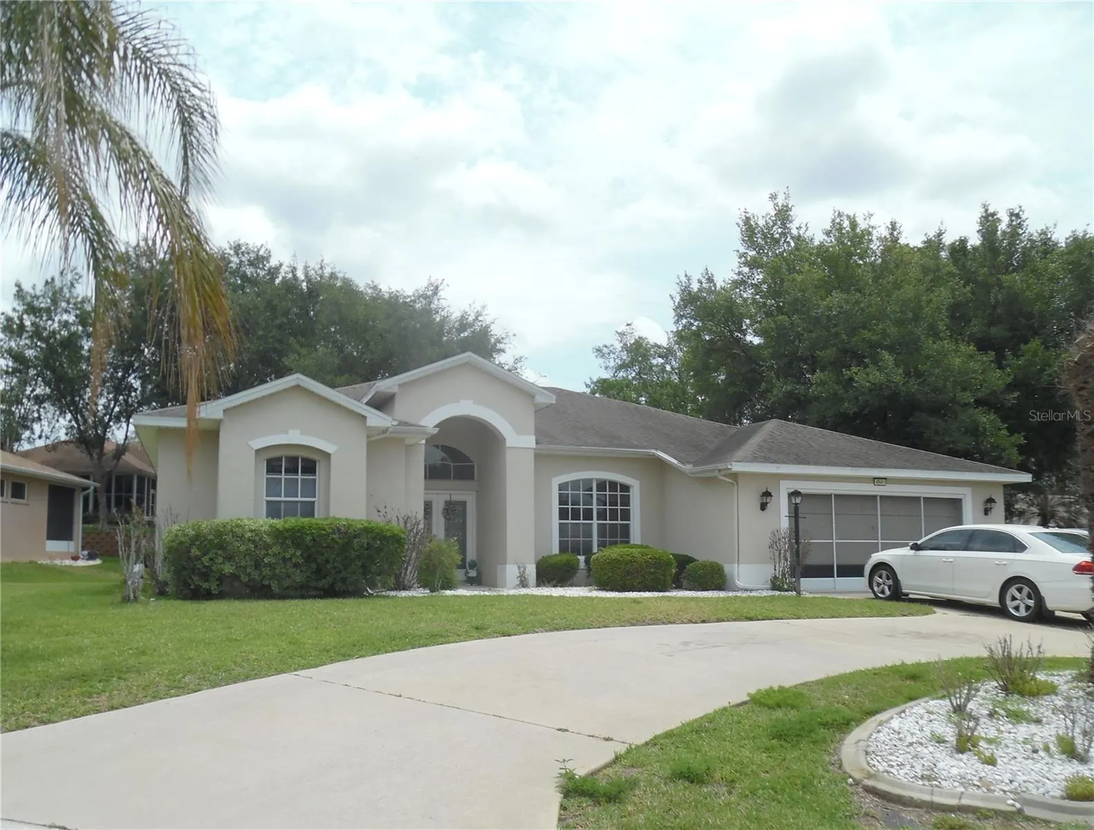 Exterior front with circular driveway on a corner lot