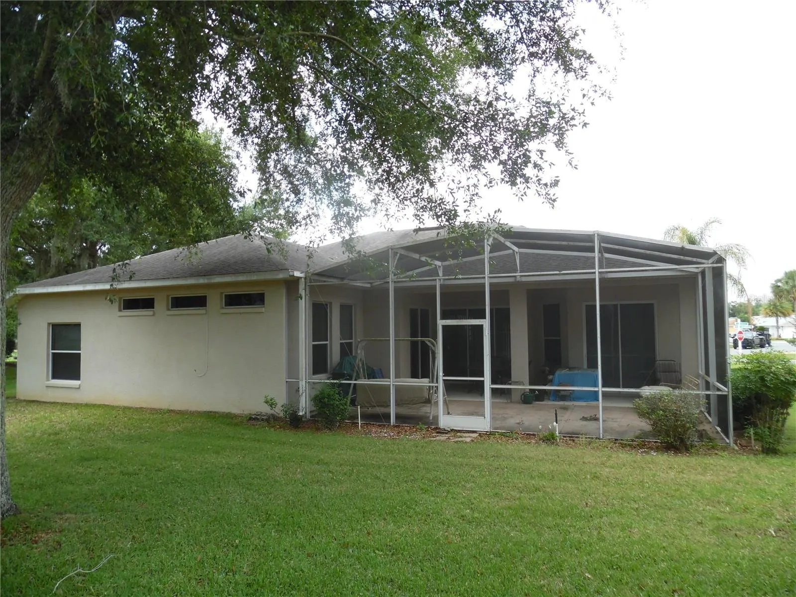 Exterior rear of home showcasing large birdcage
