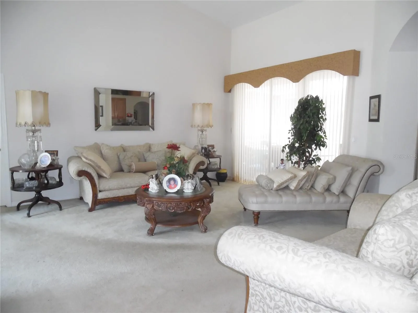 Formal living room upon entering home with sliding glass doors leading to covered patio