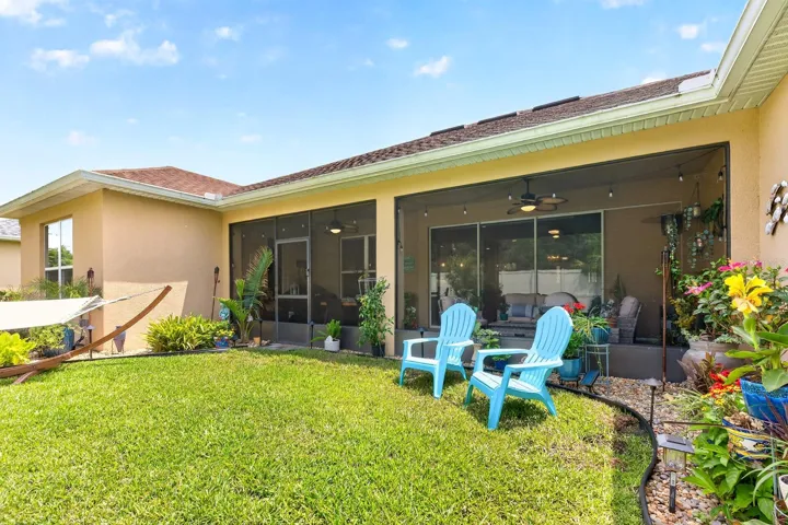 Screened lanai overlooks a nice green space.