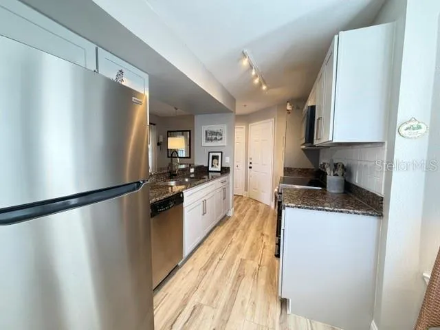 Kitchen over view - refrigerator, granite counter tops new cabinets new LV floors