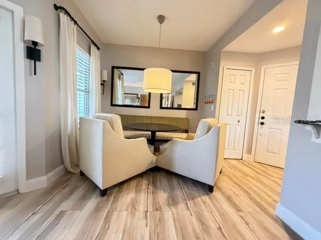 Dining area with lots of light from balcony window and brand new LV floors