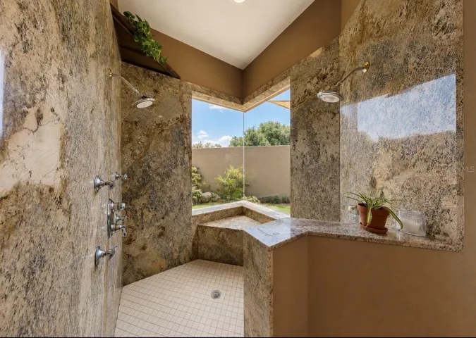 Primary shower overlooking garden and pond