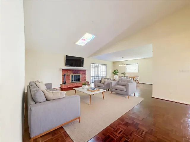 VIRTUAL STAGING - expansive living room with wood burning fireplace