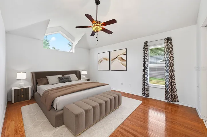The Primary Suite is thoughtfully positioned apart from the secondary bedrooms, creating a PEACEFUL PRIVATE RETREAT complete with CATHEDRAL  CEILINGS, hardwood flooring, a walk-in closet, and an ELEGANT EN SUITE BATH. Virtually Staged
