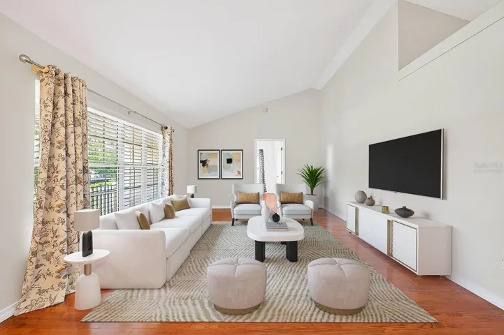 Step inside to a welcoming separate Living Room featuring HARDWOOD FLOORING and SOARING VAULTED CEILINGS, creating a bright and elegant first impression. Virtually Staged