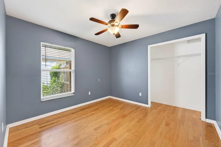TWO ADDITIONAL BEDROOMS feature hardwood flooring and sleek ceiling fans and are conveniently located near the second full bath. Bedroom 3