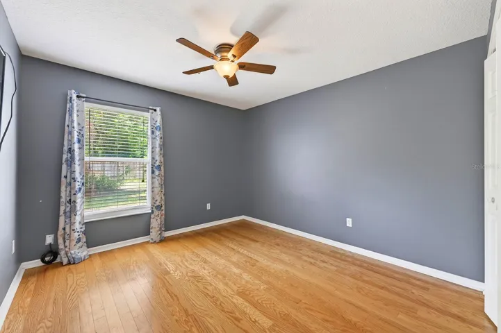 TWO ADDITIONAL BEDROOMS feature hardwood flooring and sleek ceiling fans and are conveniently located near the second full bath. Bedroom 2