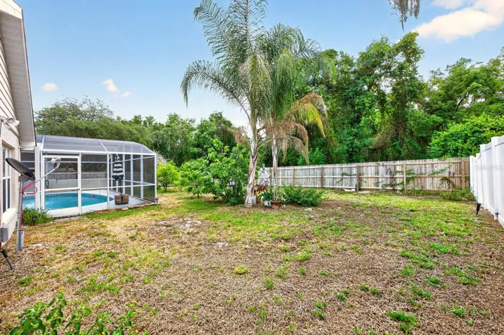Beyond the lanai, the SPACIOUS FENCED BACKYARD provides endless possibilities, whether you envision gardening, play areas, or additional outdoor entertaining spaces.