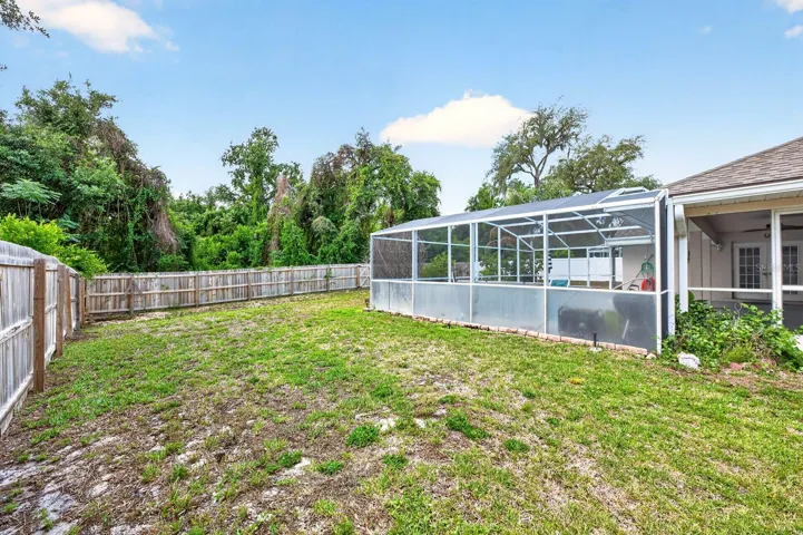 Beyond the lanai, the SPACIOUS FENCED BACKYARD provides endless possibilities, whether you envision gardening, play areas, or additional outdoor entertaining spaces.