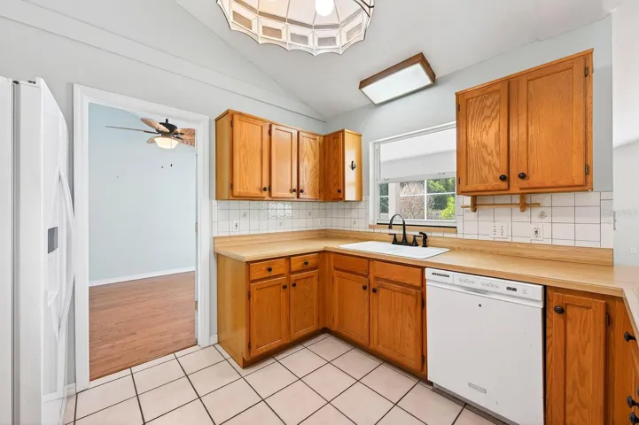 The home’s OPEN LAYOUT continues into the spacious Kitchen, Dining area, and Family Room, all enhanced by beautiful ARCHITECTURAL DETAILS and abundant NATURAL LIGHT.