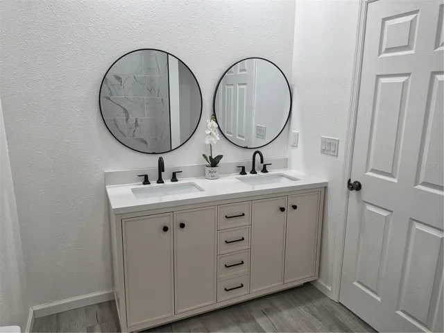 Modern bathroom featuring double sinks