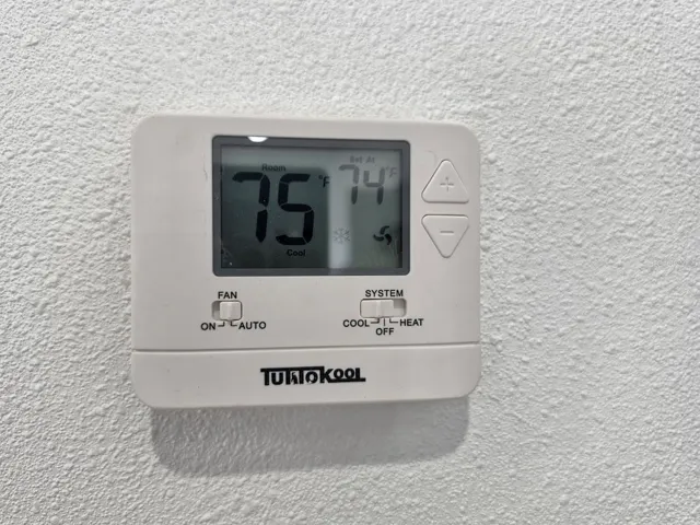 Modern thermostat controls provide added comfort and energy efficiency throughout the home.