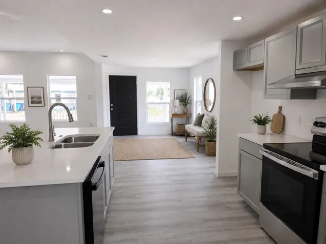 Virtually staged view showing front entrance from the kitchen.