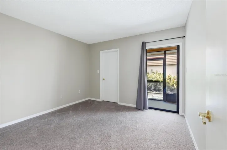 third bedroom with two closets and slider to lanai