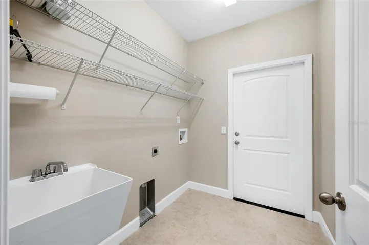 Interior Laundry room leading to 2 car garage