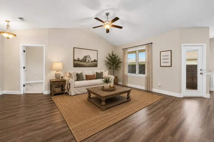 Living room virtually staged leading to primary bedroom