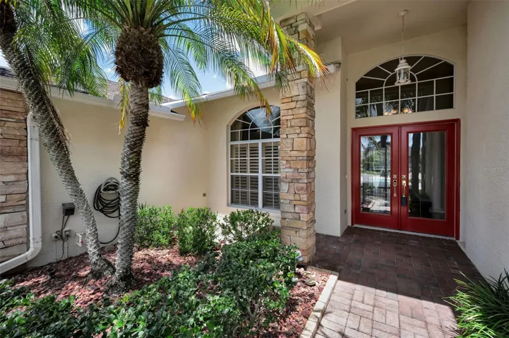 Double door entry with a nice arched window