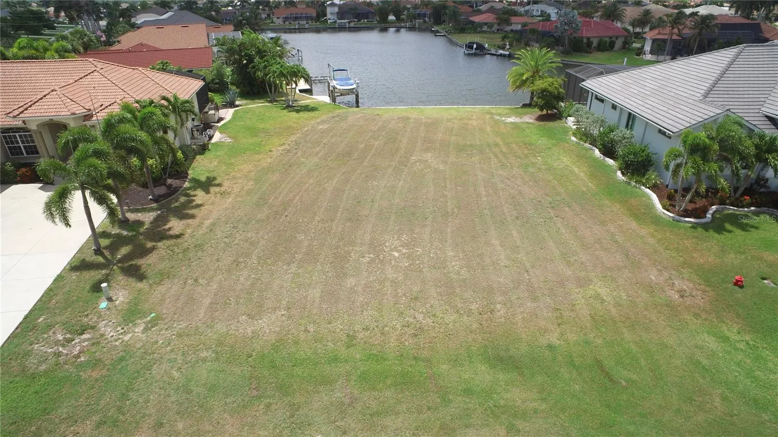 Aerial view of this residential, waterfront lot with seawall.