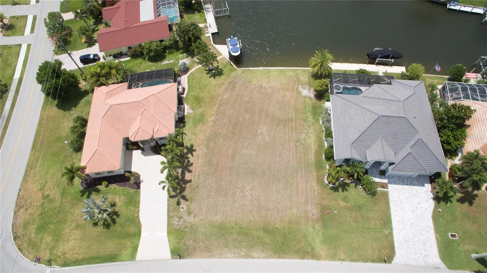 The lot is next to the corner home at Monaco Dr and Madrid Blvd.