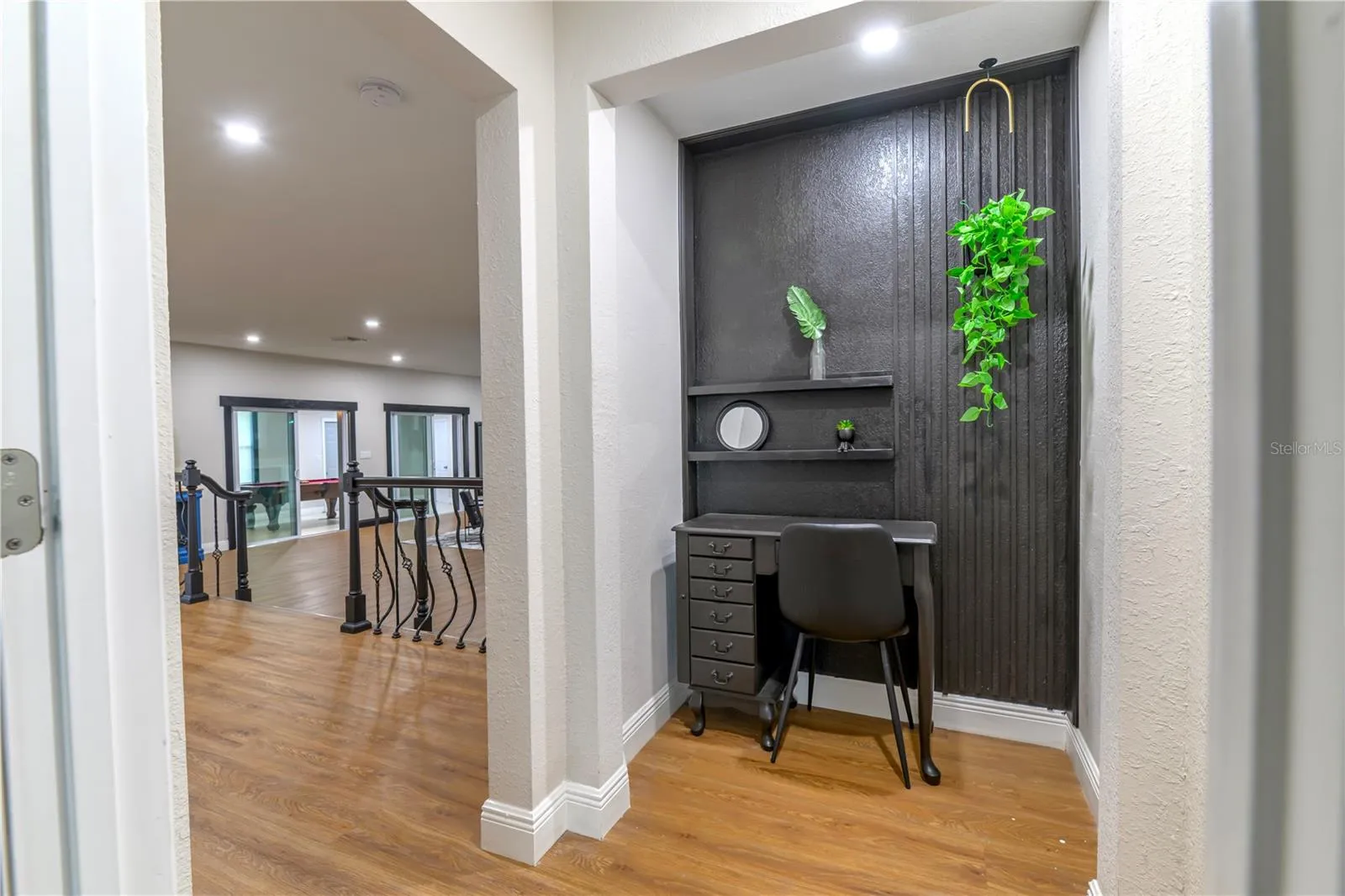 Primary Bedroom Exit into Living Room Area, Anteroom with Wood Slat Wall Accents