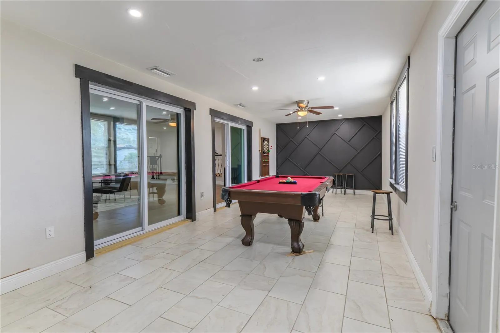 Florida Room with AC, Sliding Doors, and Wood Slat Wall Accents