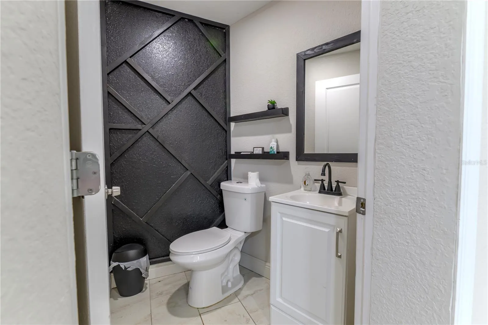 Half Bath in Florida Room with Wood Slat Wall Accents and Shelves