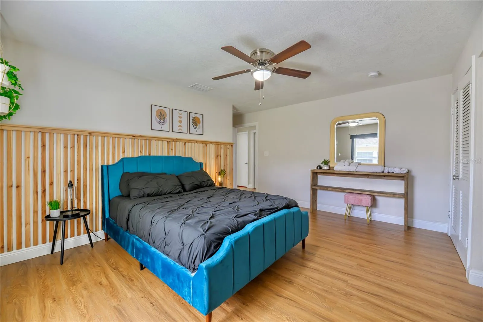 Left to Right:  Bedroom 2nd with wall mounted wood slat accents, Exit, Closet