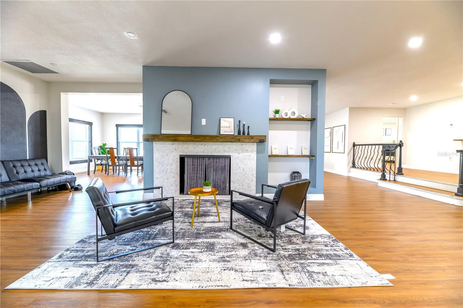 Left to Right: Dining Room Area, Fireplace Wall Cut Shelves with Wooden Shelves to the Main Living Room & Front Door, (2) Step up to Primary Bedroom Entryway