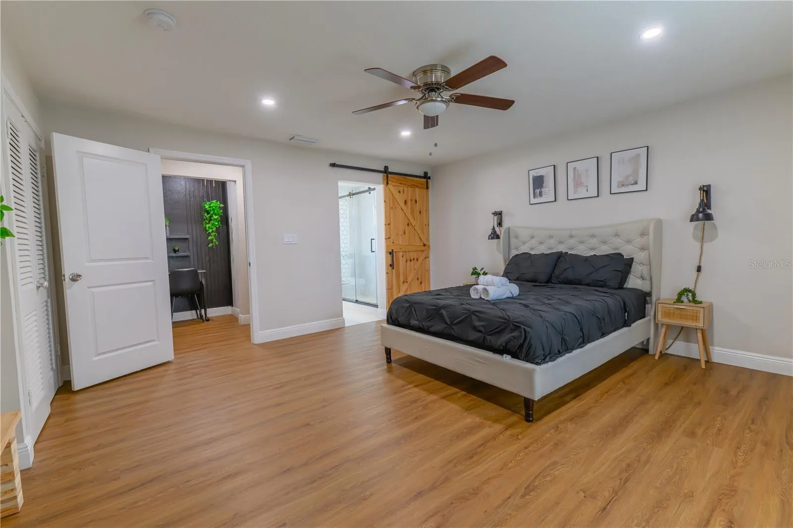 Primary Bedroom, Entryway, Barn Door into Ensuite Bathroom with Shower, & Ceiling Fan