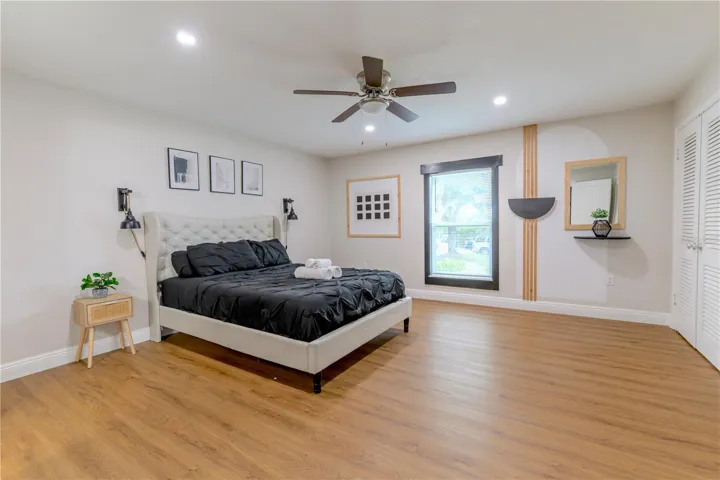 Primary Bedroom with Ceiling Fan and Wood Slat Wall Accents