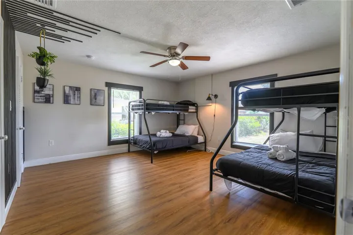 Entry View into 3rd Bedroom with Wood Slat Wall Accents & Ceiling Fan