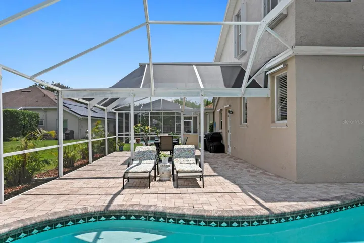 Wrap-around screened lanai and paver deck for more outdoor living space