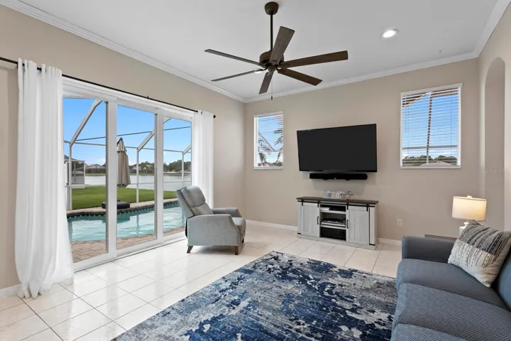 Triple sliding glass doors from family room out to the pool