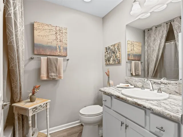 2nd bathroom offers privacy for guests and features granite countertop.