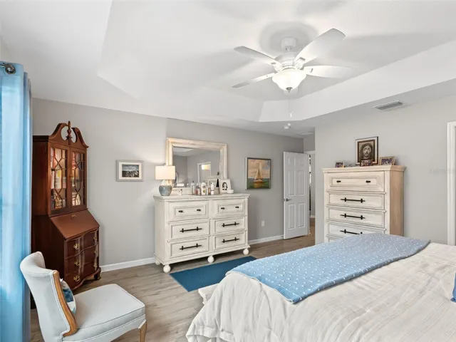 Elegant tray ceilings and sun-filled windows create a warm, inviting atmosphere.