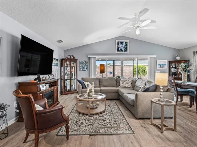 Light-filled living room with soaring ceilings and stylish vinyl flooring.